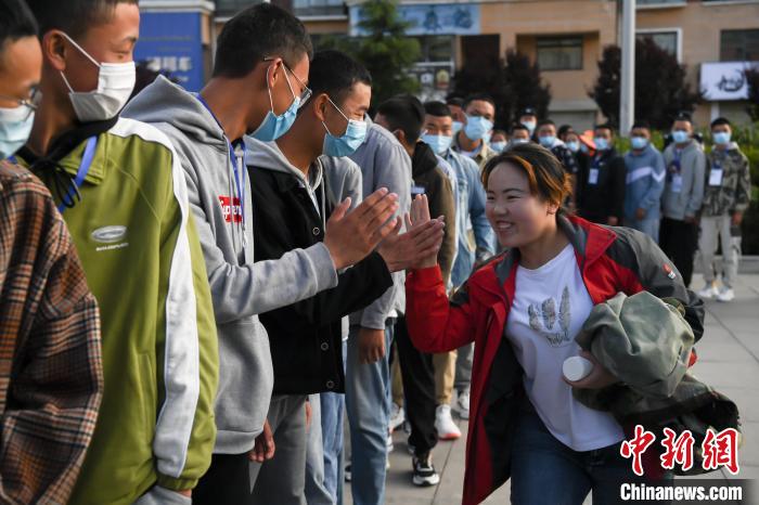 7月7日，拉薩三高考點外，領(lǐng)隊老師與考生擊掌鼓勁加油?！『闻罾?攝